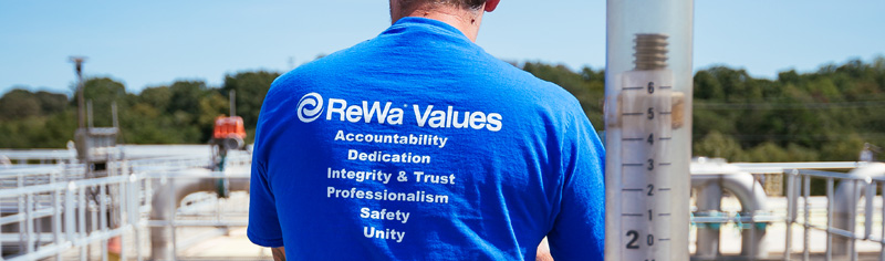 Gentleman with back facing camera and ReWa Values written on his blue tshirt